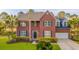 Charming two-story brick home with manicured lawn, mature trees, and an attached garage at 2524 Deer Walk Way, Mount Pleasant, SC 29466