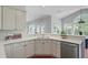 Well-lit kitchen featuring white cabinetry, granite countertops, and stainless-steel dishwasher at 2524 Deer Walk Way, Mount Pleasant, SC 29466