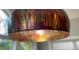 Close-up of a pendant light fixture with an interesting metallic shade at 2524 Deer Walk Way, Mount Pleasant, SC 29466