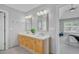 Elegant main bathroom with double sinks, a quartz countertop, and a view into the main bedroom at 2524 Deer Walk Way, Mount Pleasant, SC 29466