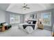 Spacious primary bedroom featuring a tray ceiling, stylish decor, and double windows at 2524 Deer Walk Way, Mount Pleasant, SC 29466