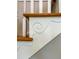 Detail of a staircase with white risers, a decorative wood element, and stained treads at 2524 Deer Walk Way, Mount Pleasant, SC 29466