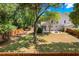Expansive backyard features mature trees, a fire pit area, and a well-maintained lawn for outdoor enjoyment at 2828 Olivia Marie Ln, Johns Island, SC 29455