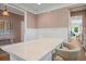 Stylish dining area featuring a quartz countertop island with seating, hardwood floors, and soft lighting throughout at 2828 Olivia Marie Ln, Johns Island, SC 29455