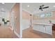 Bright dining area with white wainscoting, hardwood floors, designer fan, and natural light from multiple windows at 2828 Olivia Marie Ln, Johns Island, SC 29455