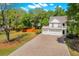 Beautiful home featuring a well-manicured lawn, brick driveway, a double garage, and classic Southern charm at 2828 Olivia Marie Ln, Johns Island, SC 29455