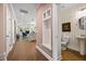 Hallway view leading into a living area and a powder room with stylish decor at 2828 Olivia Marie Ln, Johns Island, SC 29455