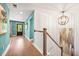 Bright hallway featuring beautiful wood floors, staircase and accent wall at 2828 Olivia Marie Ln, Johns Island, SC 29455