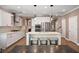 Modern kitchen with white cabinets, a spacious island with seating, and stainless steel appliances at 2828 Olivia Marie Ln, Johns Island, SC 29455