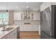 Modern kitchen boasts white cabinetry, stainless steel appliances, and a stainless range hood at 2828 Olivia Marie Ln, Johns Island, SC 29455