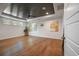 Spacious living room featuring hardwood floors, a tray ceiling, and lots of natural light at 2828 Olivia Marie Ln, Johns Island, SC 29455
