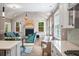 Inviting living room showcasing a fireplace, lots of natural light, cathedral ceilings, and seamless flow from the kitchen at 2828 Olivia Marie Ln, Johns Island, SC 29455