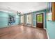 Spacious living room with hardwood floors, stylish decor, large windows and an outdoor access door at 2828 Olivia Marie Ln, Johns Island, SC 29455