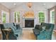Bright and airy living room showcases vaulted ceilings, fireplace, large windows, and hardwood floors at 2828 Olivia Marie Ln, Johns Island, SC 29455