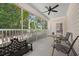 This screened-in patio offers a shaded retreat with comfortable seating and serene backyard views at 2828 Olivia Marie Ln, Johns Island, SC 29455