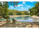 Beautiful pond with Adirondack chairs on shore, perfect for enjoying the outdoors at 2828 Olivia Marie Ln, Johns Island, SC 29455