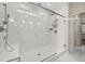 A luxurious glass enclosed shower with marble tile, rain shower head, and a built-in seat at 2828 Olivia Marie Ln, Johns Island, SC 29455