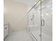 Luxurious walk-in shower with marble tiling and glass enclosure in Primary bath at 2828 Olivia Marie Ln, Johns Island, SC 29455