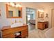 Bright bathroom with wooden vanities, vessel sinks, marble countertops, and modern fixtures at 301 Factors Walk, Summerville, SC 29485