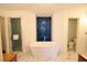 Elegant bathroom featuring a soaking tub, marble floors, and a frameless glass shower at 301 Factors Walk, Summerville, SC 29485