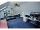 Spacious bonus room with blue carpet, ceiling fan, and workout equipment at 301 Factors Walk, Summerville, SC 29485