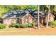 Charming brick home featuring a well-manicured lawn and mature trees providing ample shade at 301 Factors Walk, Summerville, SC 29485