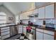Modern kitchen with stainless steel appliances, granite countertops, and white cabinetry at 301 Factors Walk, Summerville, SC 29485