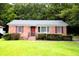 Charming brick home with a well-maintained lawn, complemented by lush greenery at 318 Amy Dr, Goose Creek, SC 29445