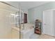 Relaxing bathroom featuring a soaking tub, separate glass shower, and woven window shades at 3500 Maplewood Ln, Mount Pleasant, SC 29466