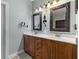 Elegant bathroom features double vanity with wood cabinets, framed mirrors, and contemporary lighting fixtures at 3500 Maplewood Ln, Mount Pleasant, SC 29466