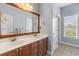 Bathroom with double sink vanity, neutral paint, and large decorative mirror at 3500 Maplewood Ln, Mount Pleasant, SC 29466