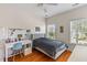 Bright bedroom features wood floors, large windows, desk and a comfy bed at 3500 Maplewood Ln, Mount Pleasant, SC 29466