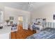 Bright bedroom features wood floors, large windows, desk and a comfy bed at 3500 Maplewood Ln, Mount Pleasant, SC 29466