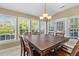 Cozy dining area with natural light, a classic chandelier, and access to the backyard at 3500 Maplewood Ln, Mount Pleasant, SC 29466
