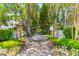 Welcoming brick path lined with lush greenery, leading to a charming home's entrance at 3500 Maplewood Ln, Mount Pleasant, SC 29466