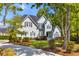 A light blue two-story home featuring a driveway, green lawn, and mature trees in a serene neighborhood setting at 3500 Maplewood Ln, Mount Pleasant, SC 29466