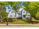Charming two-story home with light blue siding, black shutters, and a beautifully landscaped front yard at 3500 Maplewood Ln, Mount Pleasant, SC 29466