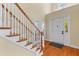Grand foyer features soaring ceilings, hardwood floors, a white front door, and an elegant staircase with wood accents at 3500 Maplewood Ln, Mount Pleasant, SC 29466
