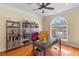 Bright home office with hardwood floors, large window, and contemporary desk and shelving units at 3500 Maplewood Ln, Mount Pleasant, SC 29466