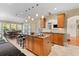 Well-lit kitchen features a central island, wooden cabinets, and open layout to the dining area at 3500 Maplewood Ln, Mount Pleasant, SC 29466