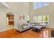 Bright living room features soaring ceilings, a large sectional sofa, hardwood floors, and an open floor plan at 3500 Maplewood Ln, Mount Pleasant, SC 29466