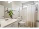 Well-lit bathroom featuring a white vanity, toilet, shower with curtain, and unique wall art for a modern look at 3526 Stockton Dr, Mount Pleasant, SC 29466