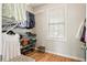 Organized closet with ample shelving, hanging space, wood floors, and a window providing natural light at 3526 Stockton Dr, Mount Pleasant, SC 29466