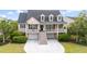 Charming exterior showcasing the home's double porches, dormer windows, and beautifully landscaped front yard at 3526 Stockton Dr, Mount Pleasant, SC 29466