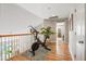 Bright upstairs hallway with hardwood floors, white walls, and an exercise bike at 3526 Stockton Dr, Mount Pleasant, SC 29466