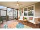 Cozy screened porch with wicker chairs and a ceiling fan at 3526 Stockton Dr, Mount Pleasant, SC 29466