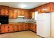 Traditional kitchen featuring wood cabinets, a white refrigerator, and ample counter space for meal preparation at 356 Price St, Goose Creek, SC 29445