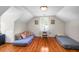 Finished attic with twin mattresses and a table, flooded with natural light at 41 Berkeley Rd, Charleston, SC 29407