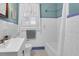 Bright bathroom with a shower-tub combo, white tiled walls, and a pedestal sink at 41 Berkeley Rd, Charleston, SC 29407