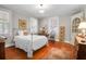 Cozy bedroom with hardwood floors, lots of natural light, and vintage furniture at 41 Berkeley Rd, Charleston, SC 29407